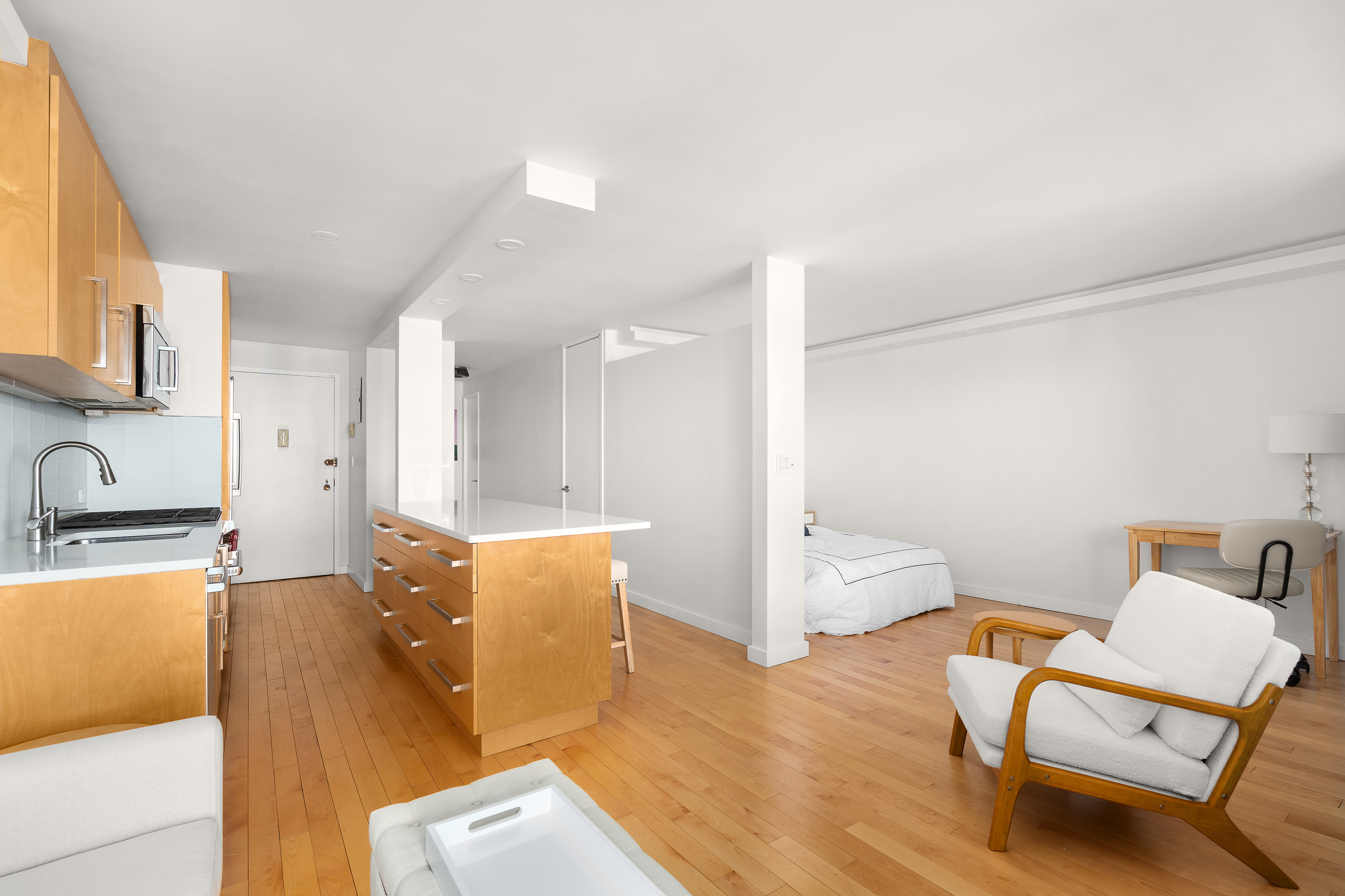 75 Henry Street, Unit 23D Brooklyn, NY 11201 - Photo 3 of 8 a living room with furniture and a wooden floor