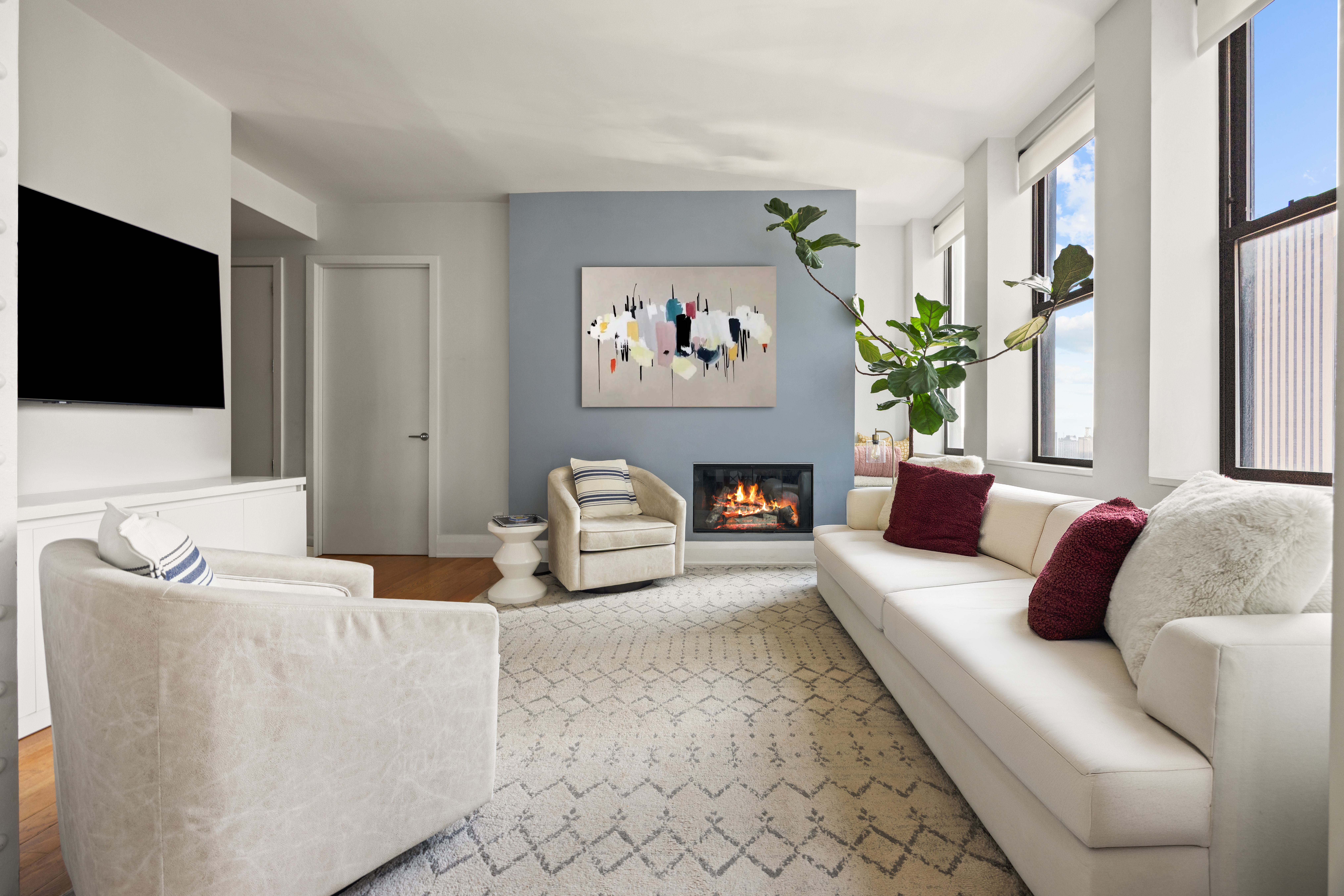 150 Nassau Street, Unit 17D Manhattan, NY 10038 - Photo 2 of 16 a living room with furniture and a flat screen tv