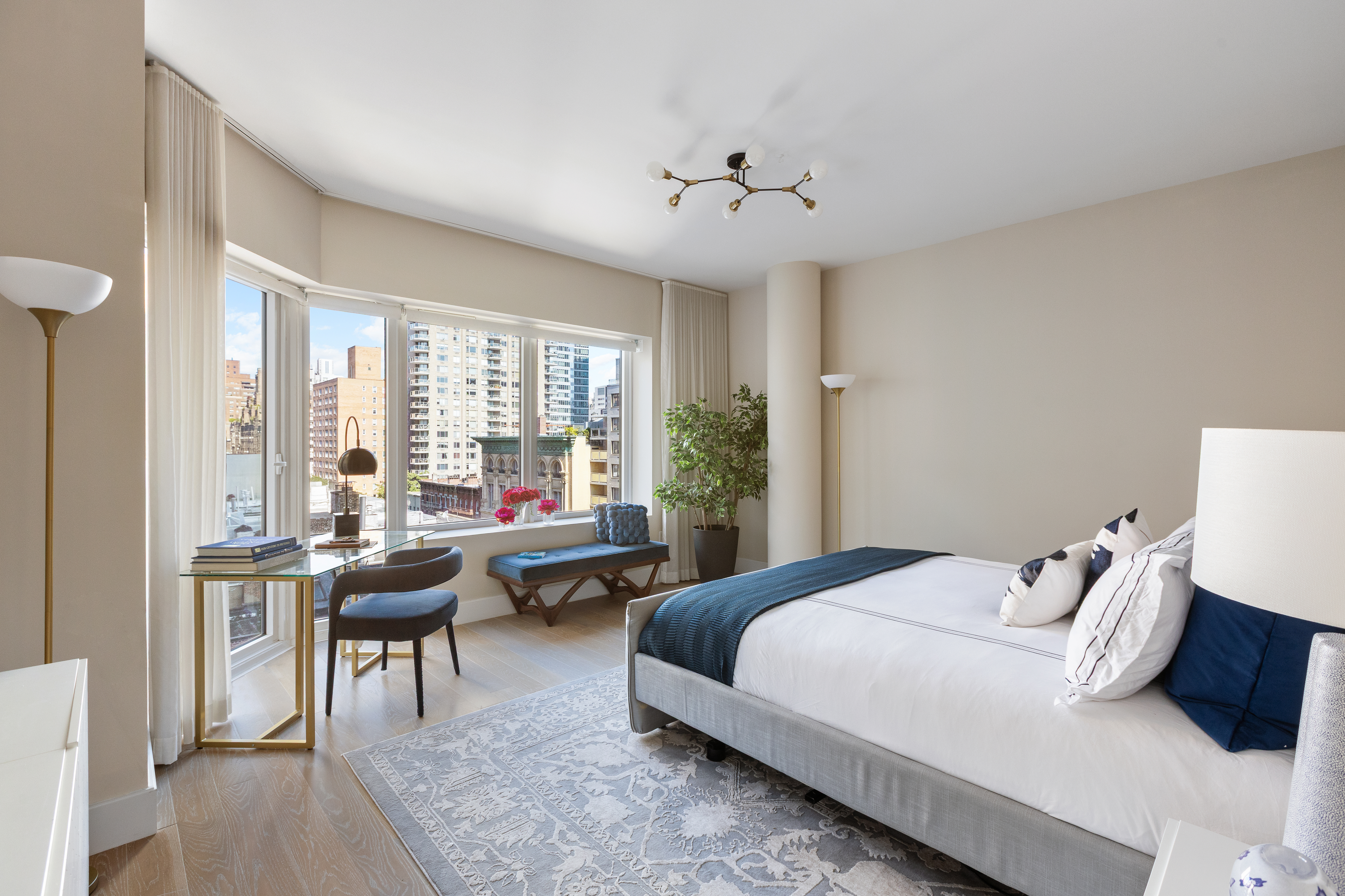 1355 1st Avenue, Unit 8 Manhattan, NY 10021 - Photo 14 of 25 a bedroom with a bed and a chandelier