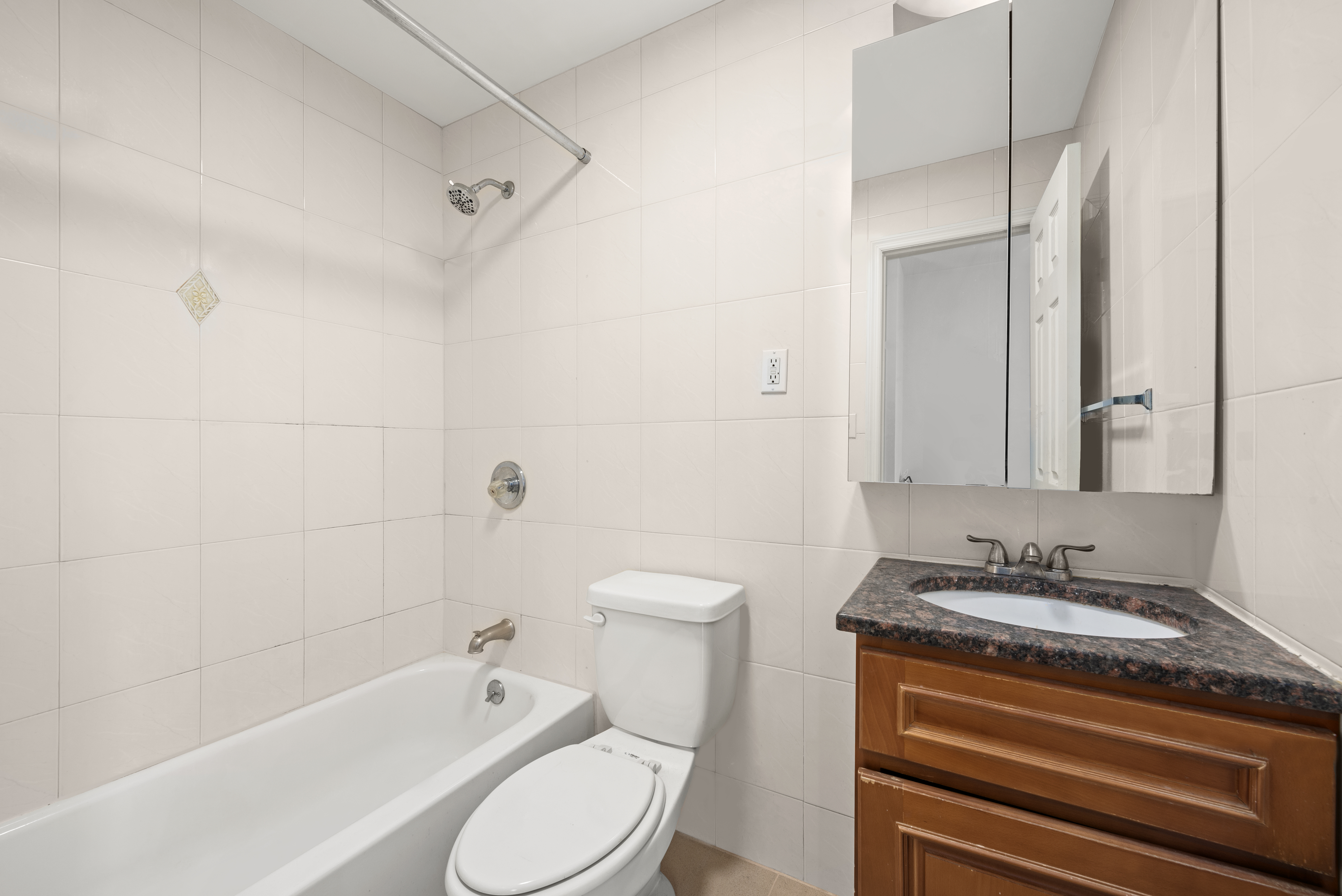 25 Bogart Street, Unit 2N Brooklyn, NY 11206 - Photo 5 of 7 a bathroom with a granite countertop toilet sink and shower