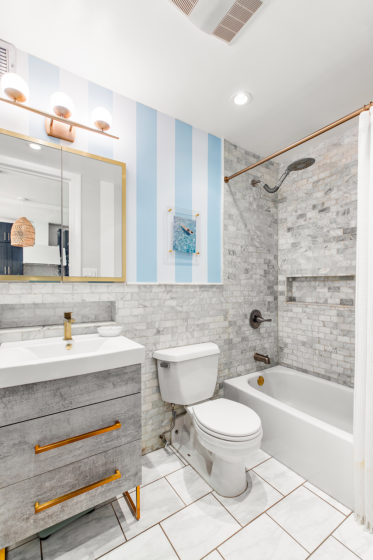 529 West 42nd Street, Unit 9R Manhattan, NY 10036 - Photo 9 of 10 a bathroom with a toilet a sink a mirror and bathtub