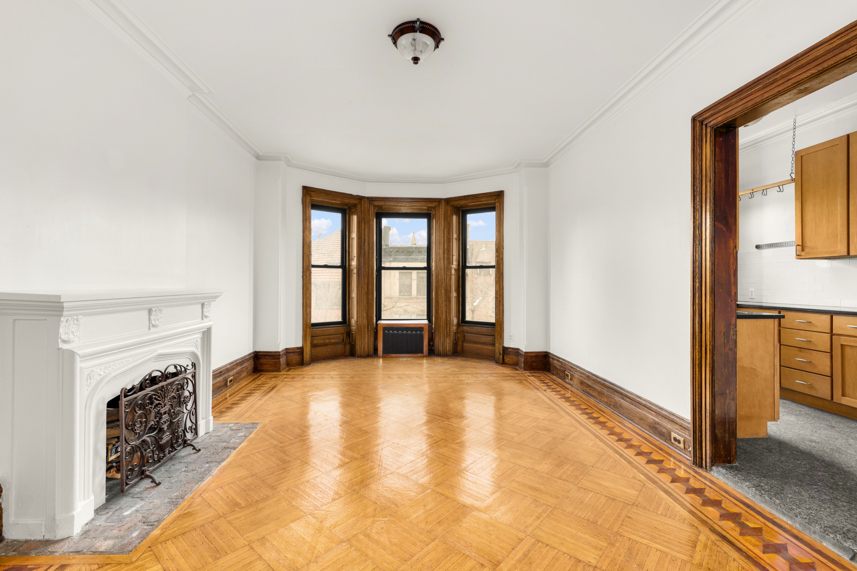 a view of an empty room with window and a fireplace
