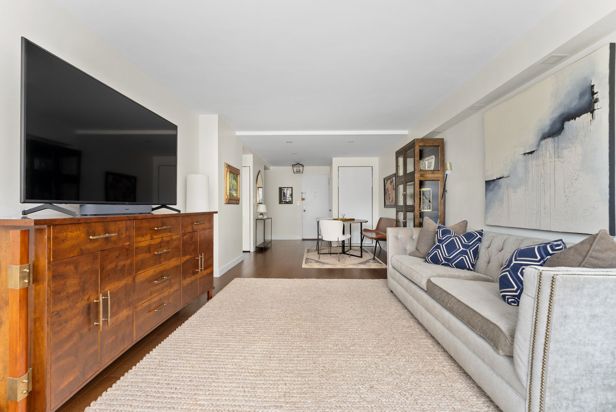 15 West 72nd Street, Unit 22O Manhattan, NY 10023 - Photo 4 of 8 a living room with furniture and a flat screen tv