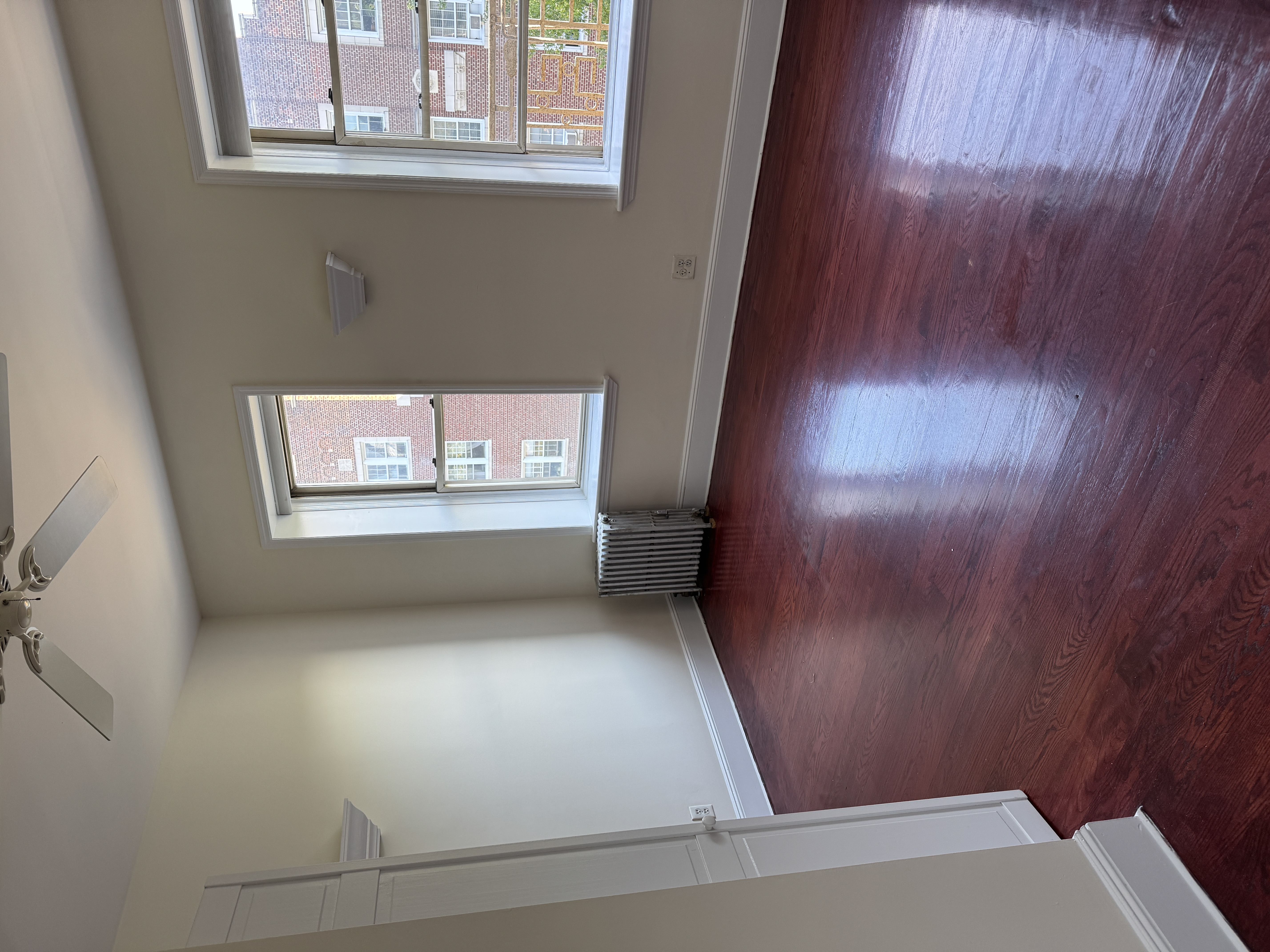 260 Cumberland Street, Unit 21 Brooklyn, NY 11205 - Photo 8 of 13 an empty room with wooden floor and windows