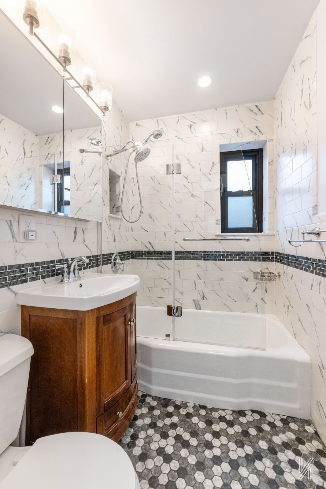 34-10 94th Street, Unit 6G Queens, NY 11372 - Photo 17 of 19 a bathroom with a sink a toilet and bathtub