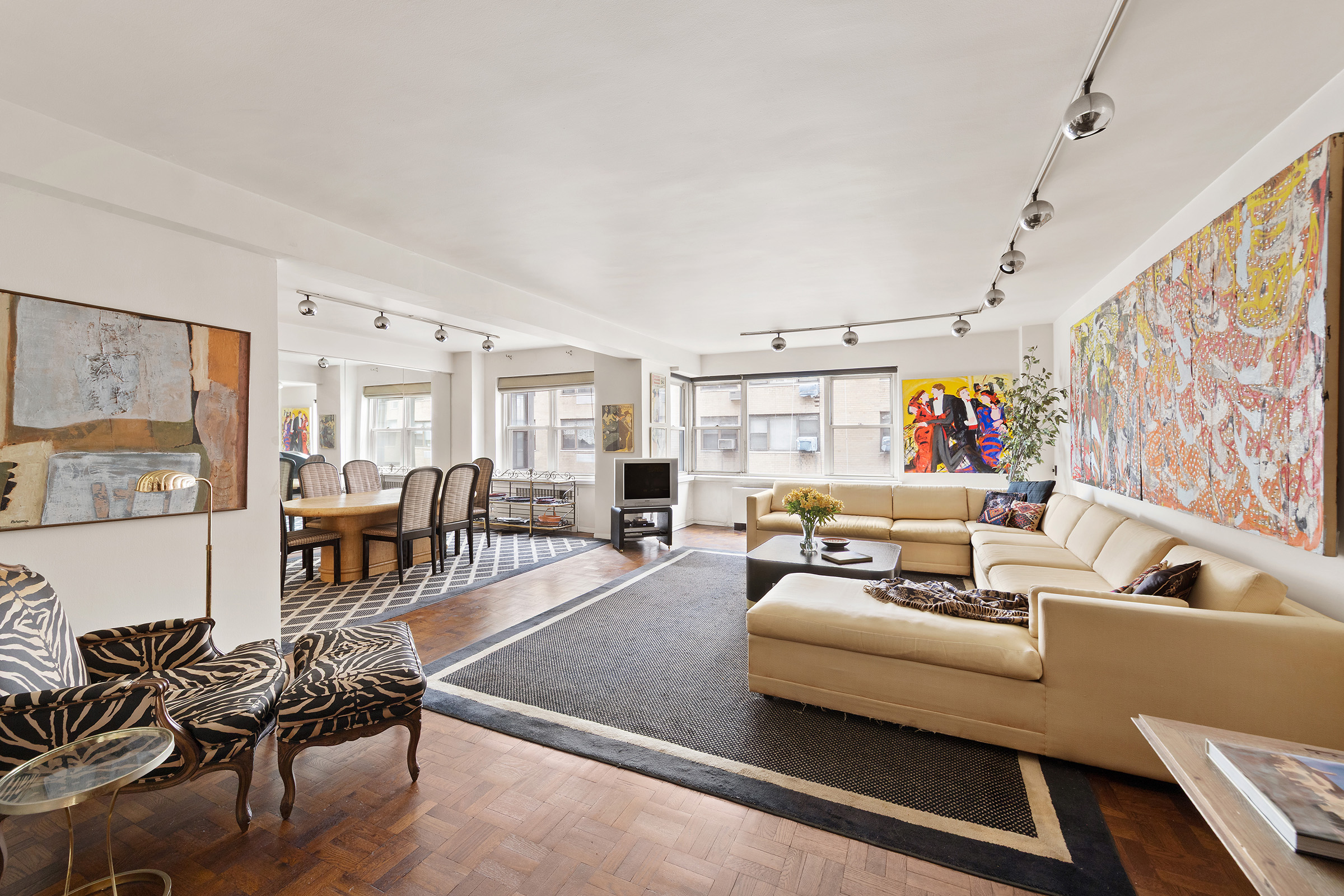 a living room with furniture and wooden floor