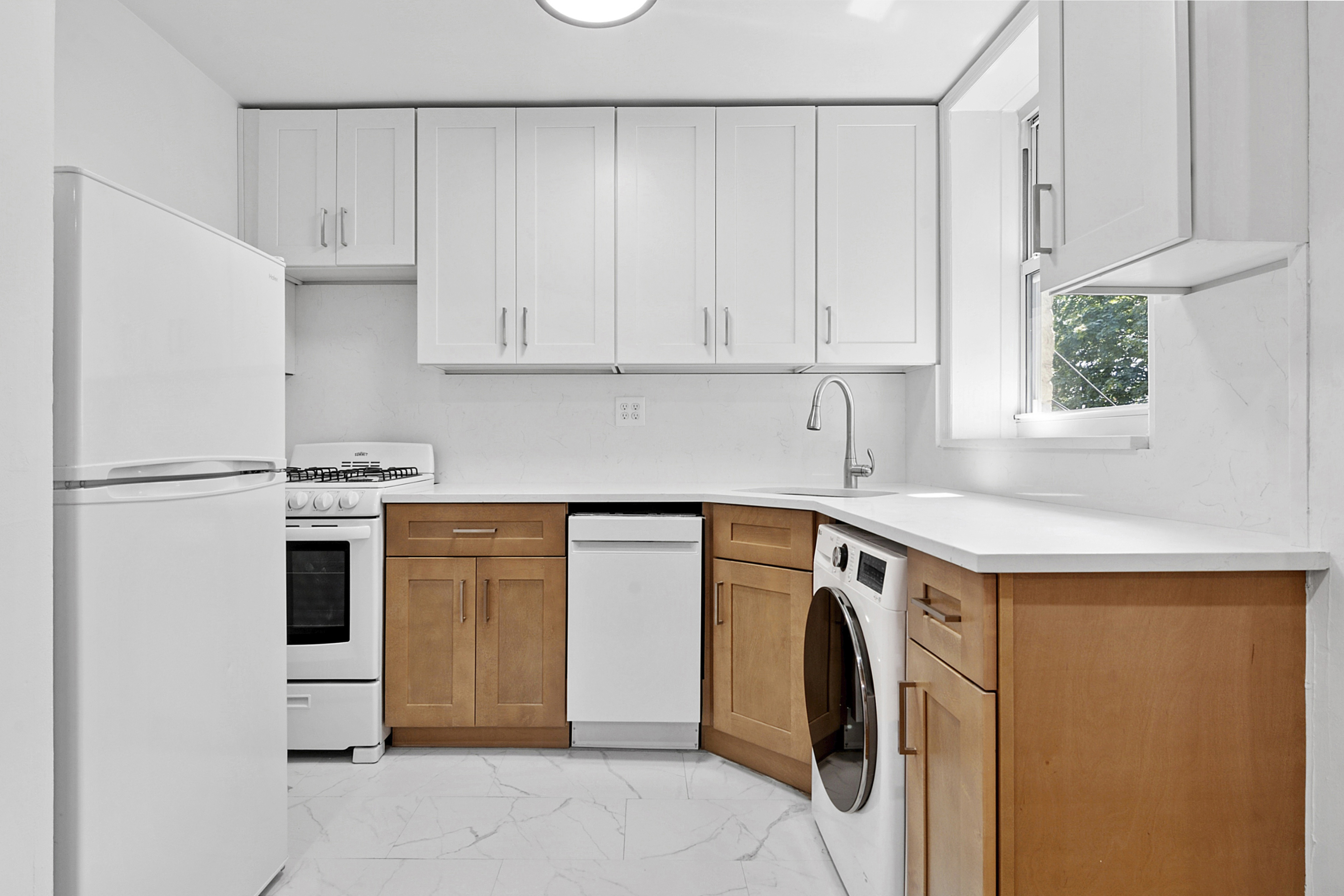 104 Dean Street, Unit 3R Brooklyn, NY 11201 - Photo 5 of 6 a utility room with stainless steel appliances white cabinets and a sink