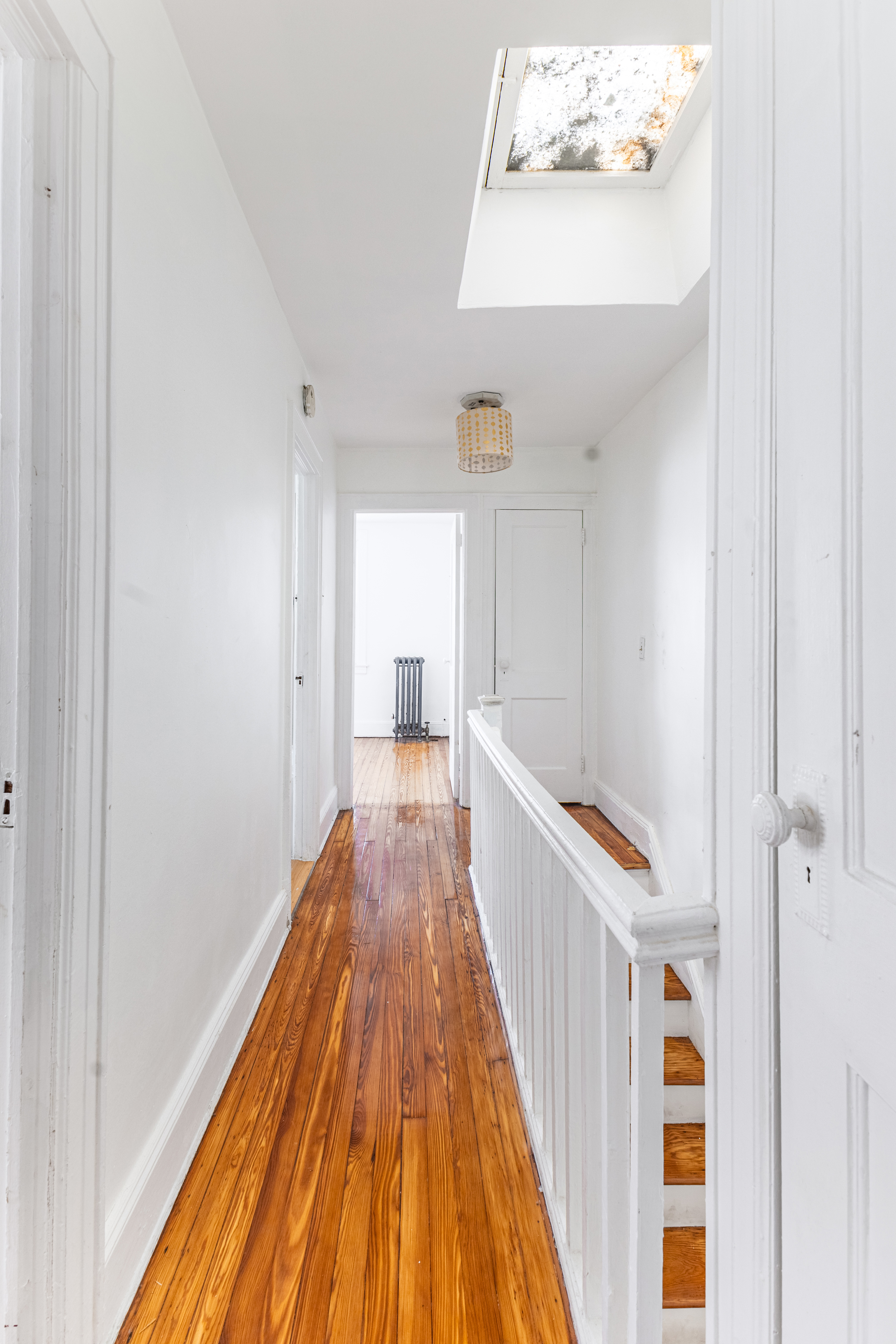 69-29 67th Place Queens, NY 11385 - Photo 15 of 24 a view of a hallway with wooden floor