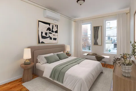 a bedroom with a bed and wooden floor