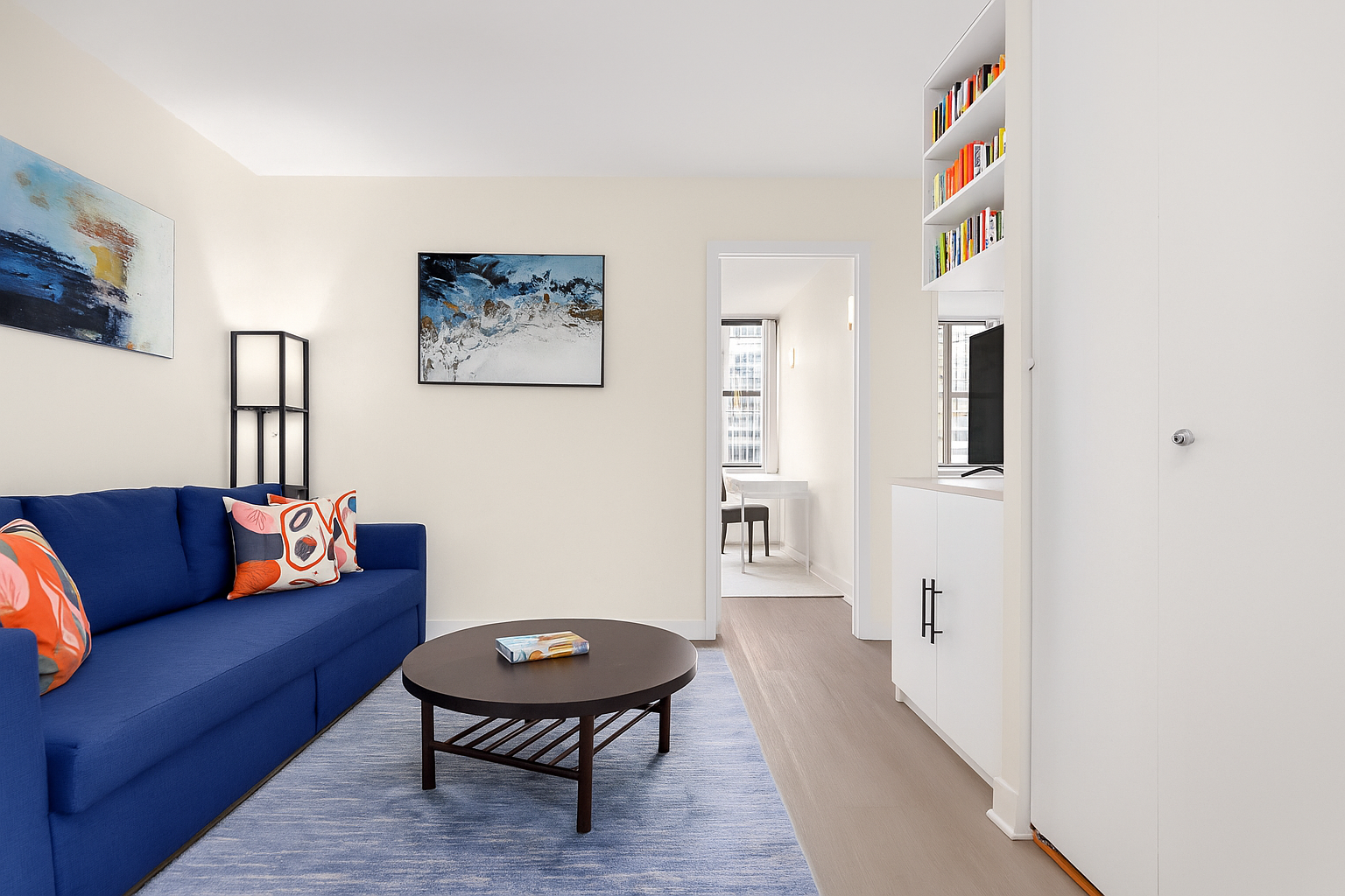 301 East 45th Street, Unit 11F Manhattan, NY 10017 - Photo 2 of 9 a living room with furniture and a wooden floor