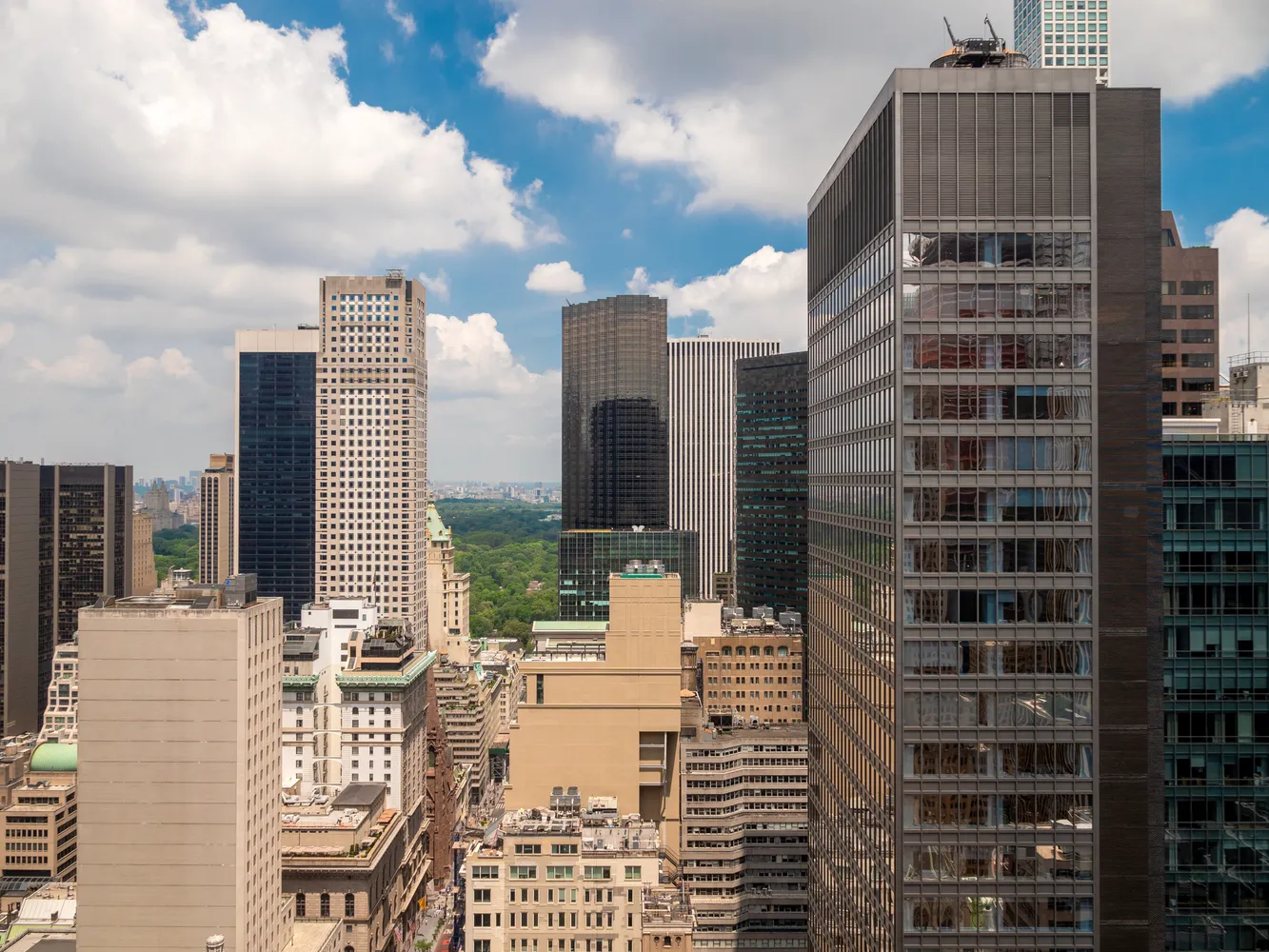 a bedroom with a large bed and a flat tv screen on a dresser