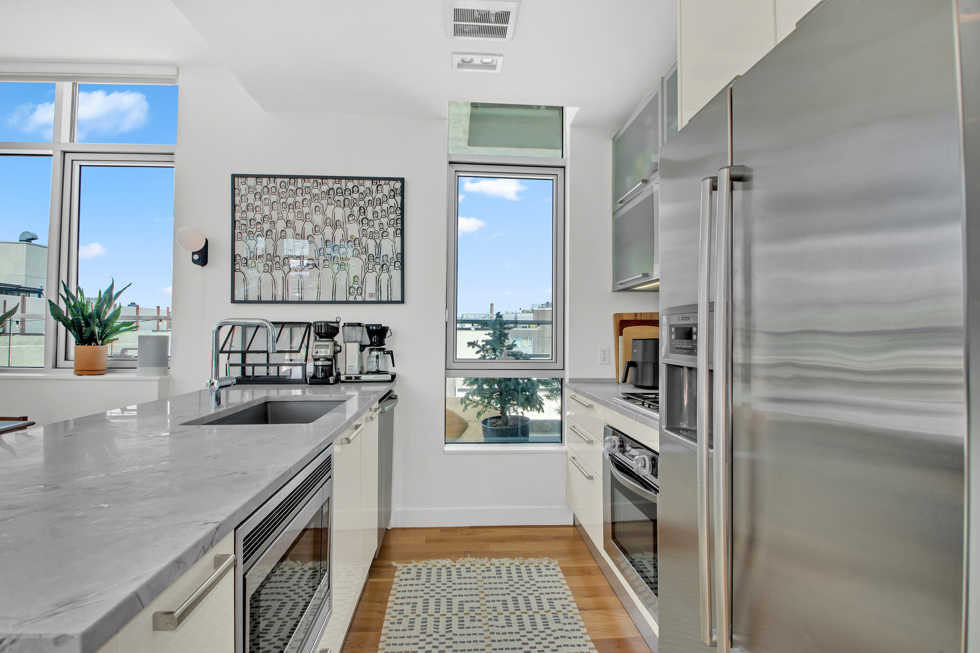 101 North 5th Street, Unit 5A Brooklyn, NY 11249 - Photo 10 of 26 a kitchen with a refrigerator and a sink