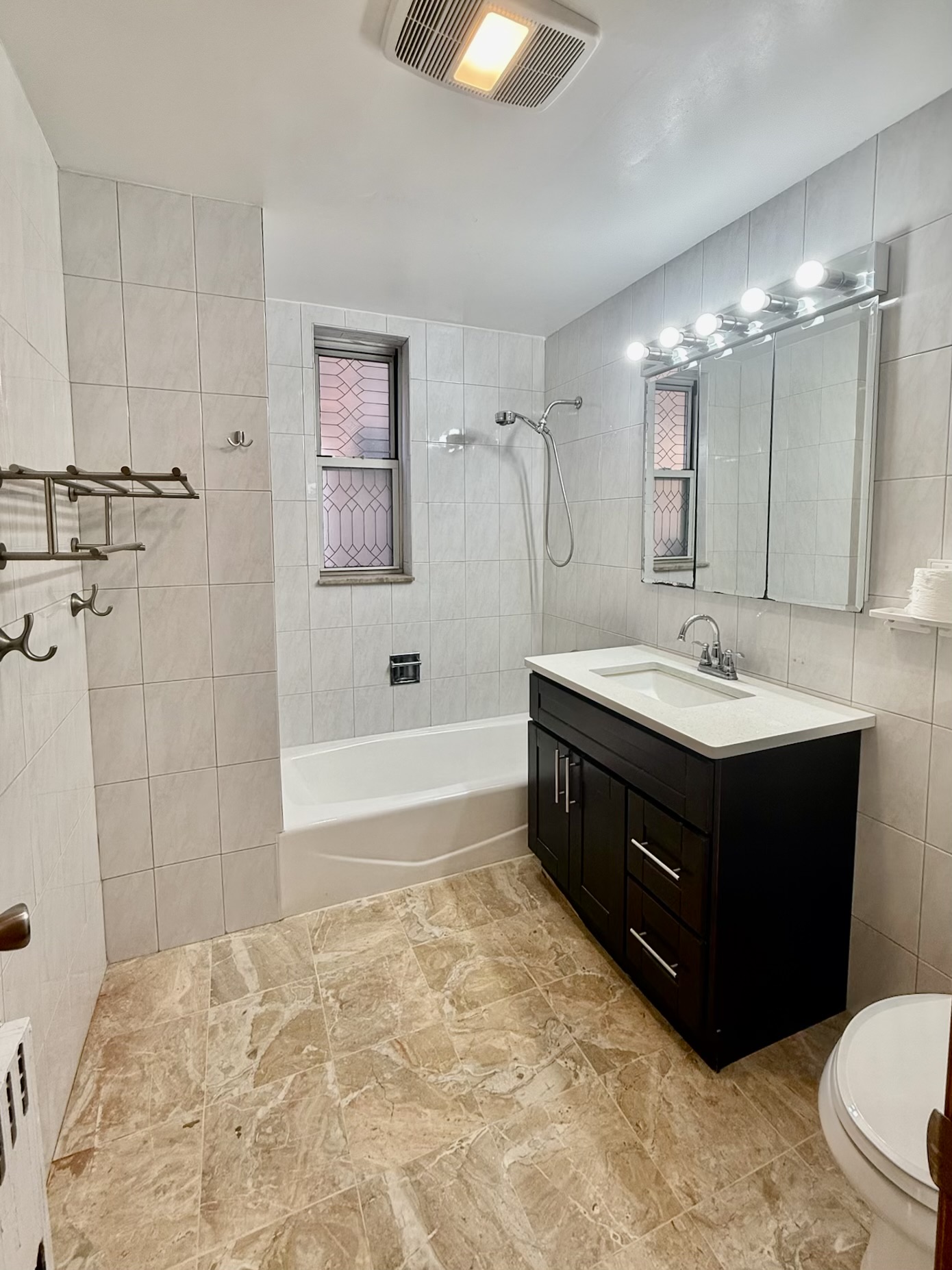 18-48 21st Drive, Unit 1R Queens, NY 11105 - Photo 6 of 11 a bathroom with a sink double vanity and a bathtub