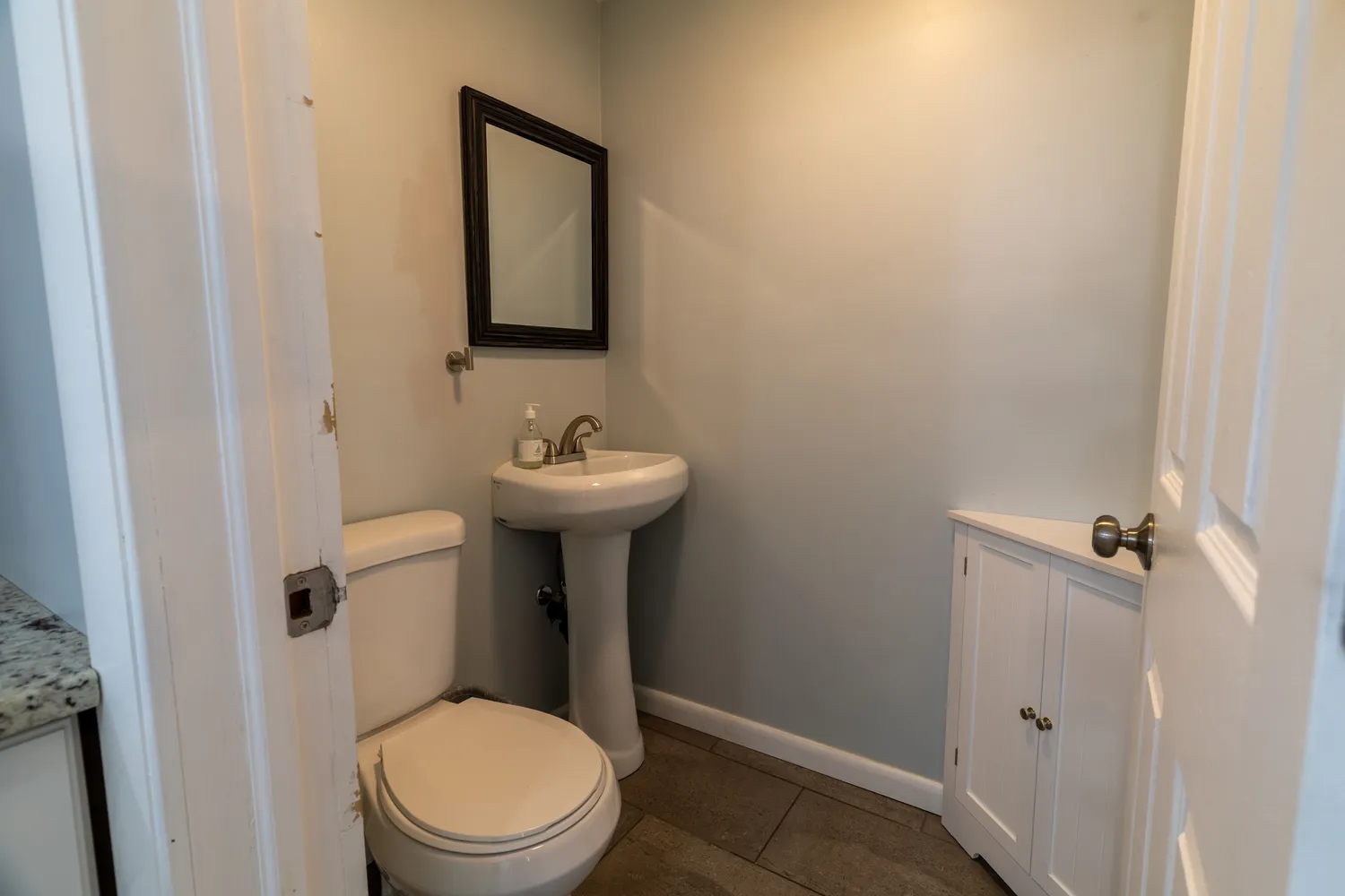 a kitchen with kitchen island granite countertop a sink stove and refrigerator