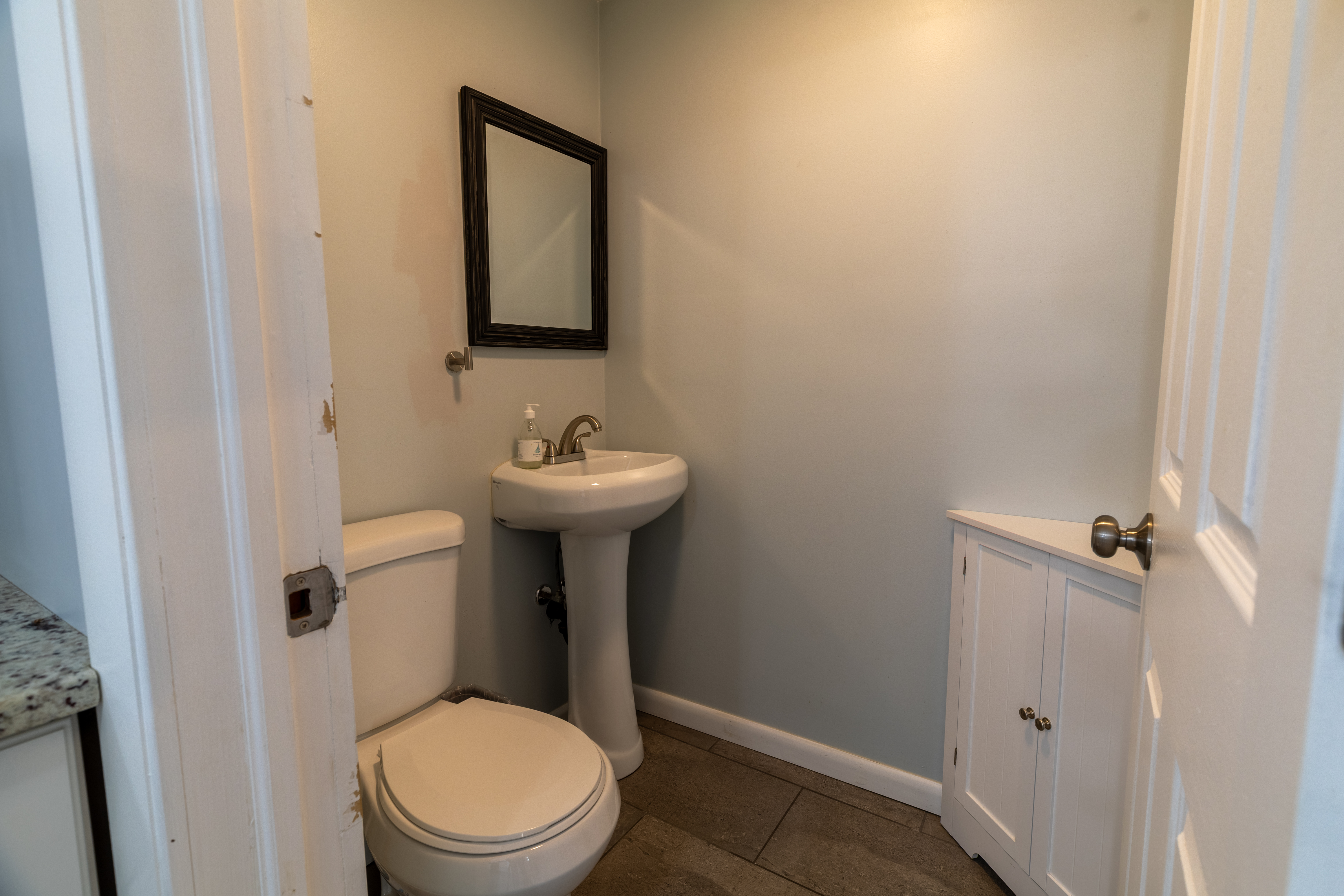 90 School Street New London, CT 06320 - Photo 11 of 34 a white toilet sitting next to a white sink