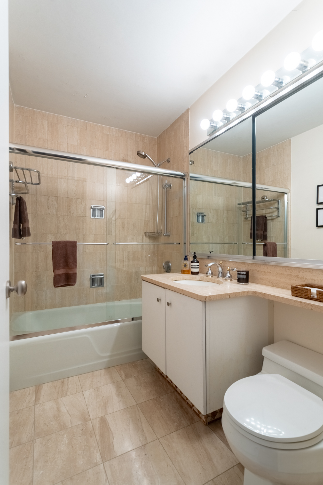 50 East 89th Street, Unit 31C Manhattan, NY 10128 - Photo 12 of 18 a bathroom with a sink toilet and shower