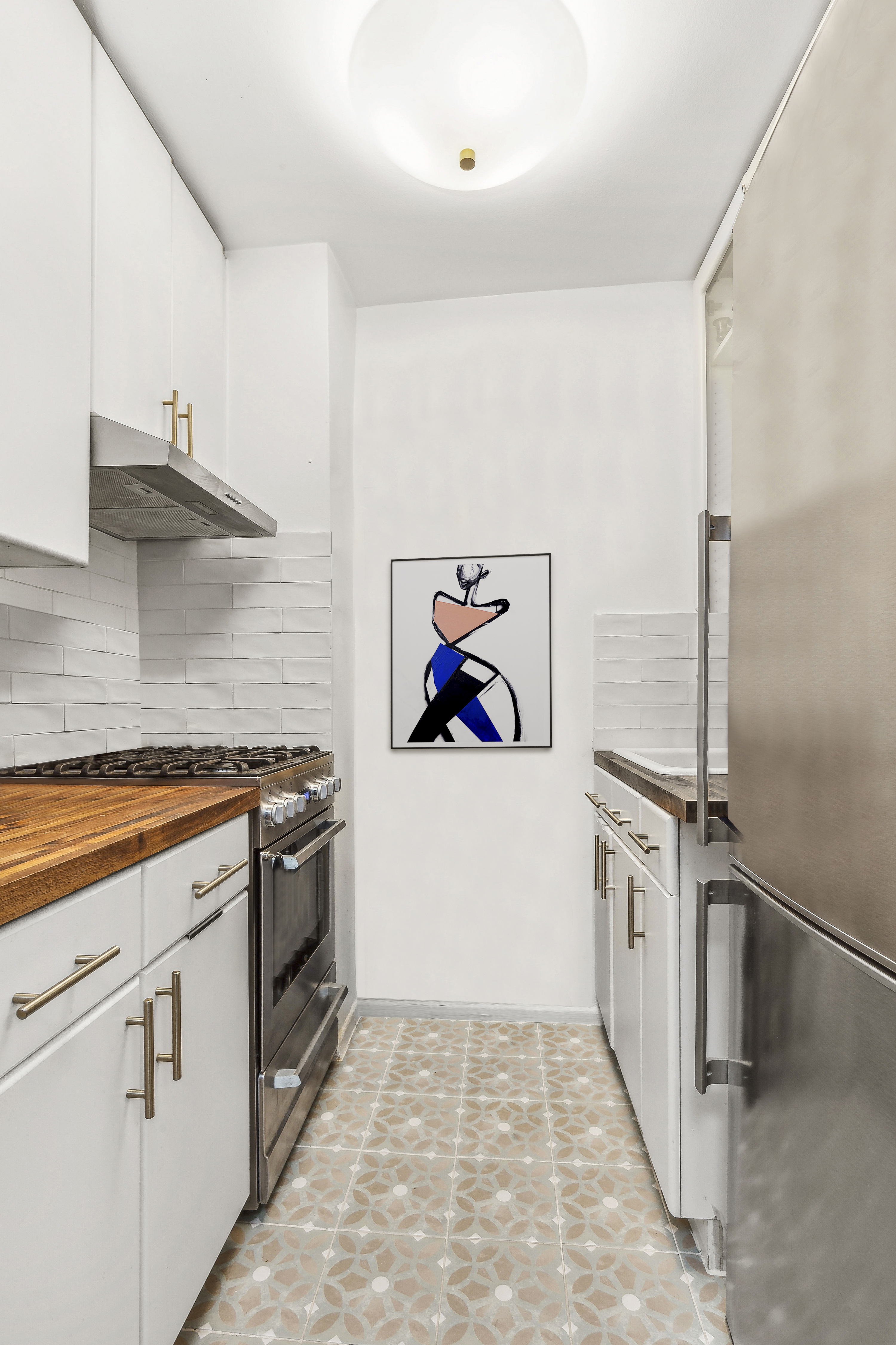 13 West 13th Street, Unit 2DS Manhattan, NY 10011 - Photo 8 of 19 a kitchen with stainless steel appliances granite countertop a stove a sink and a refrigerator