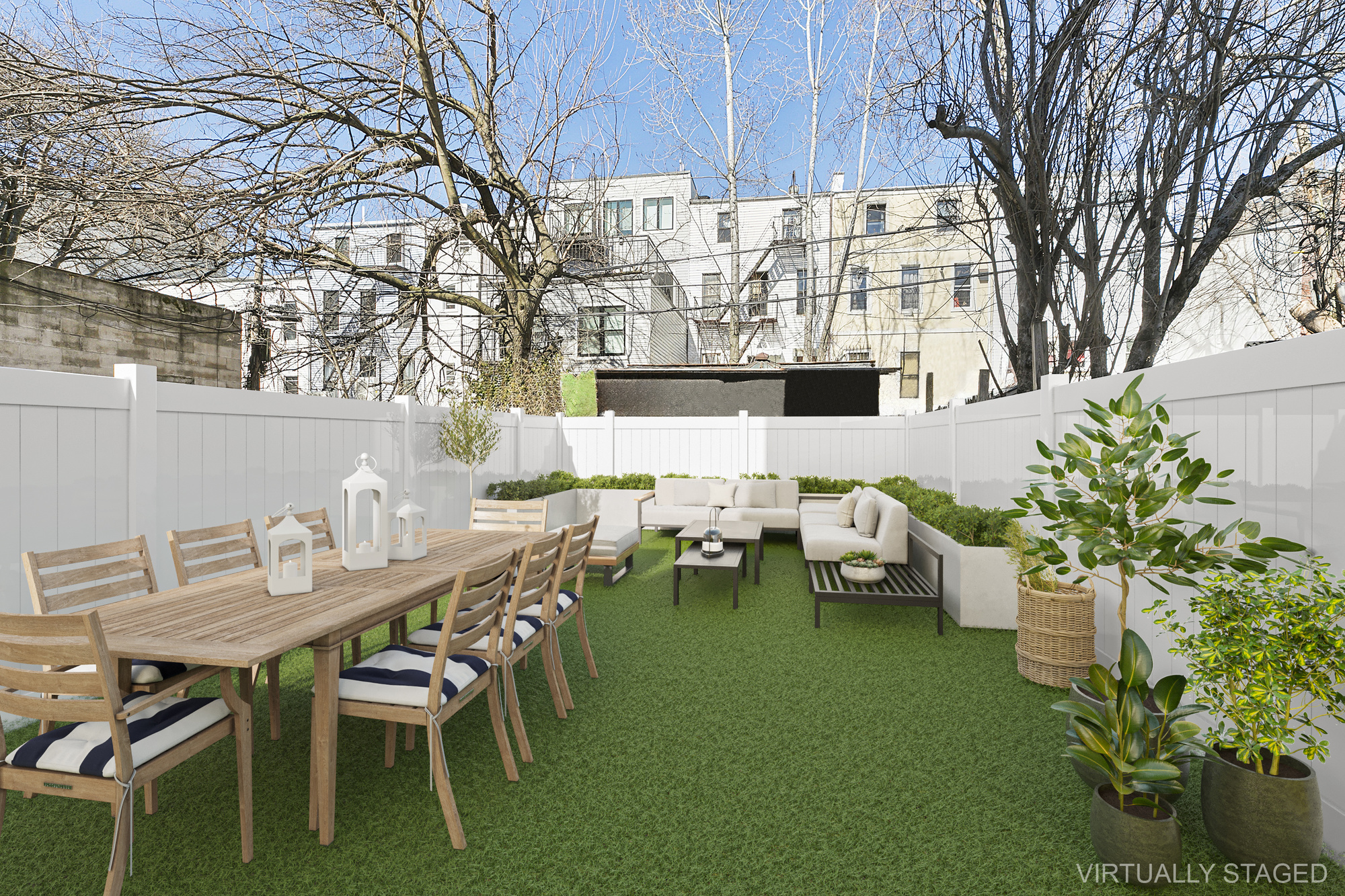 a view of a patio with table and chairs potted plants and large tree