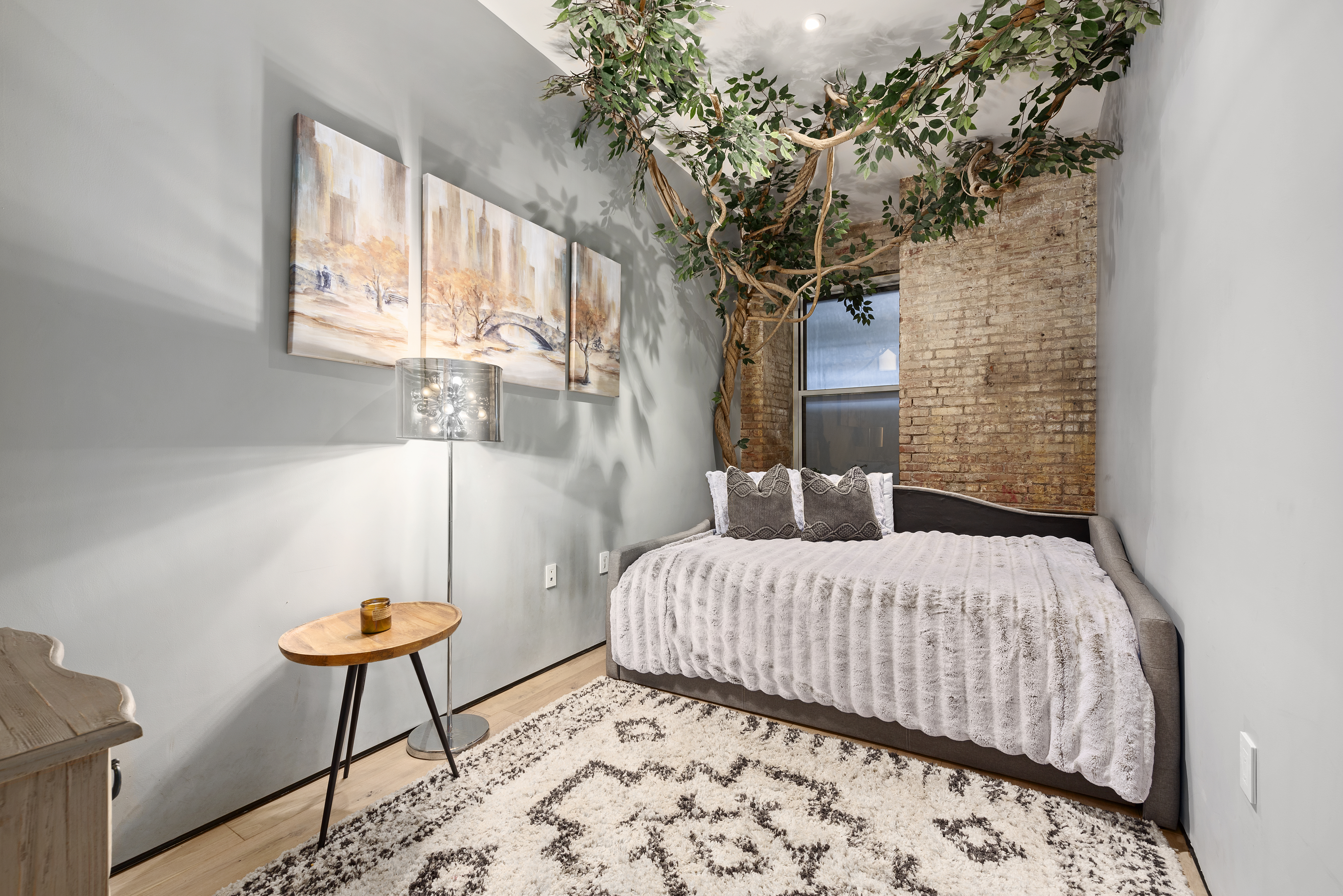 10 Bleecker Street, Unit 1B Manhattan, NY 10012 - Photo 11 of 16 a bedroom with a bed and a potted plant
