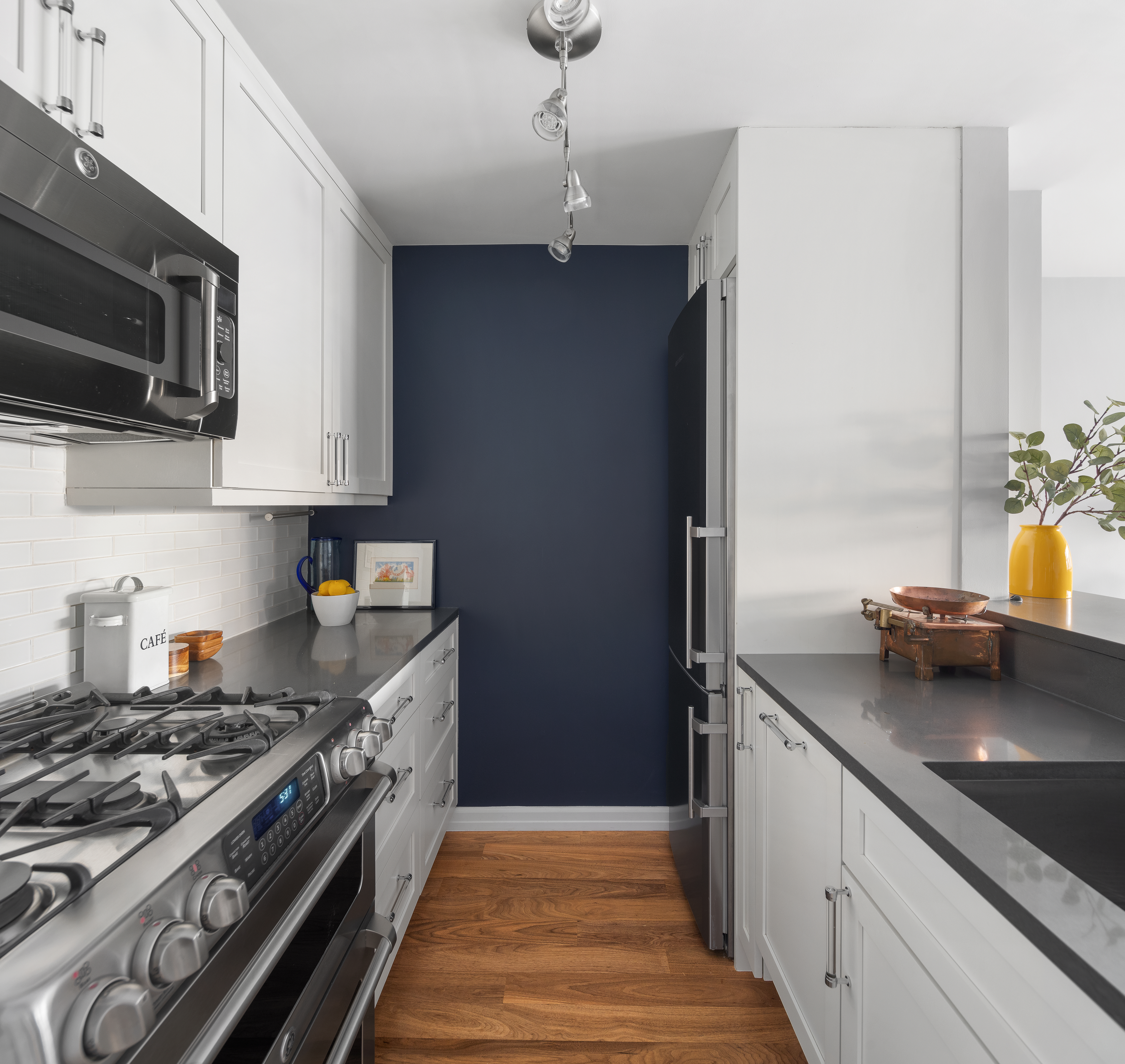 225 East 57th Street, Unit 9M Manhattan, NY 10022 - Photo 5 of 10 a kitchen with stainless steel appliances granite countertop a sink stove and microwave