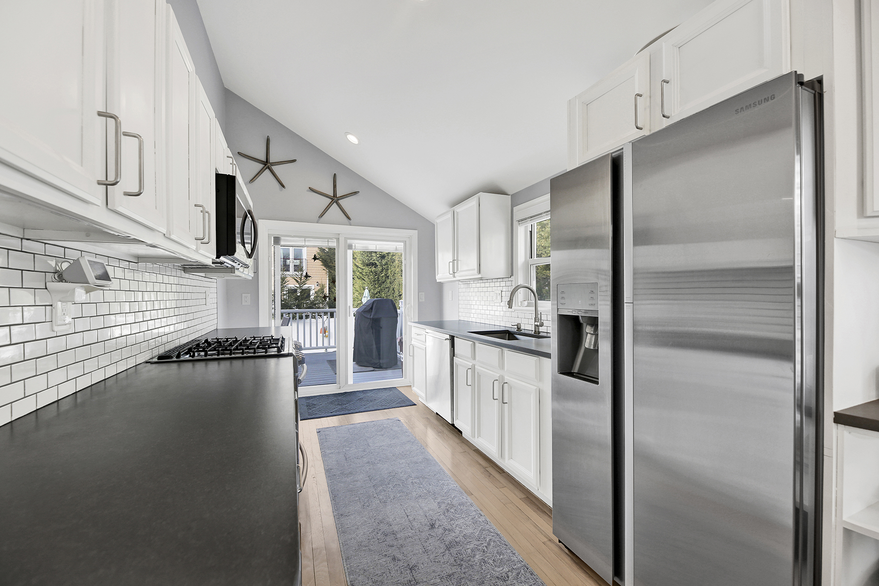 4-53 Beach 142nd Street Queens, NY 11694 - Photo 16 of 39 a kitchen with refrigerator and white cabinets
