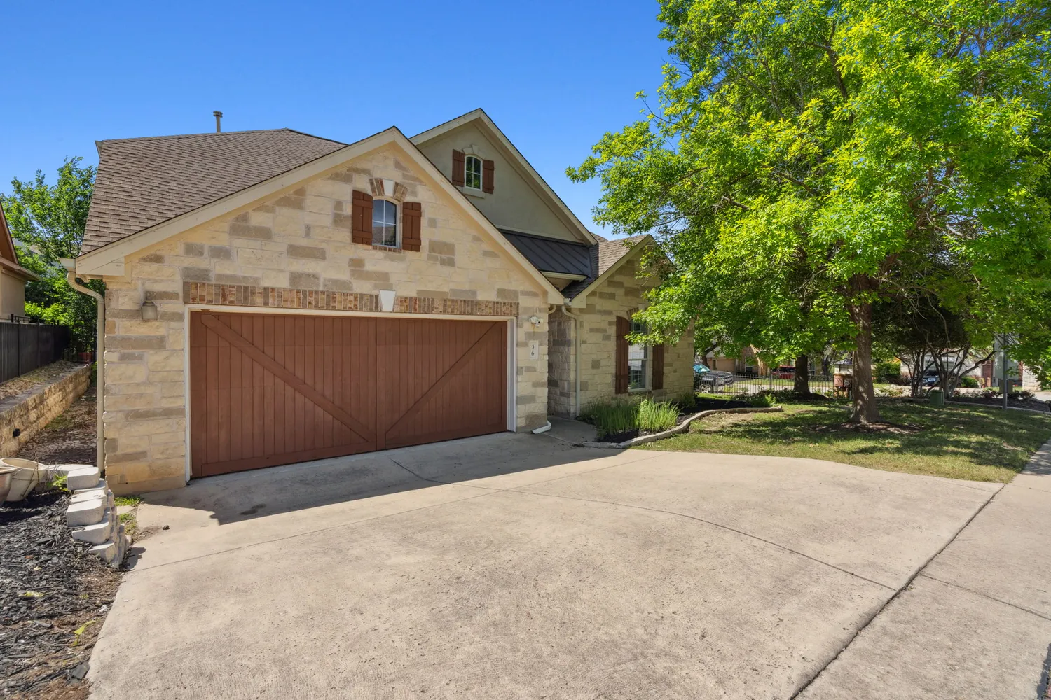 a front view of house with yard and trees around