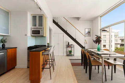 a dining room with furniture and wooden floor