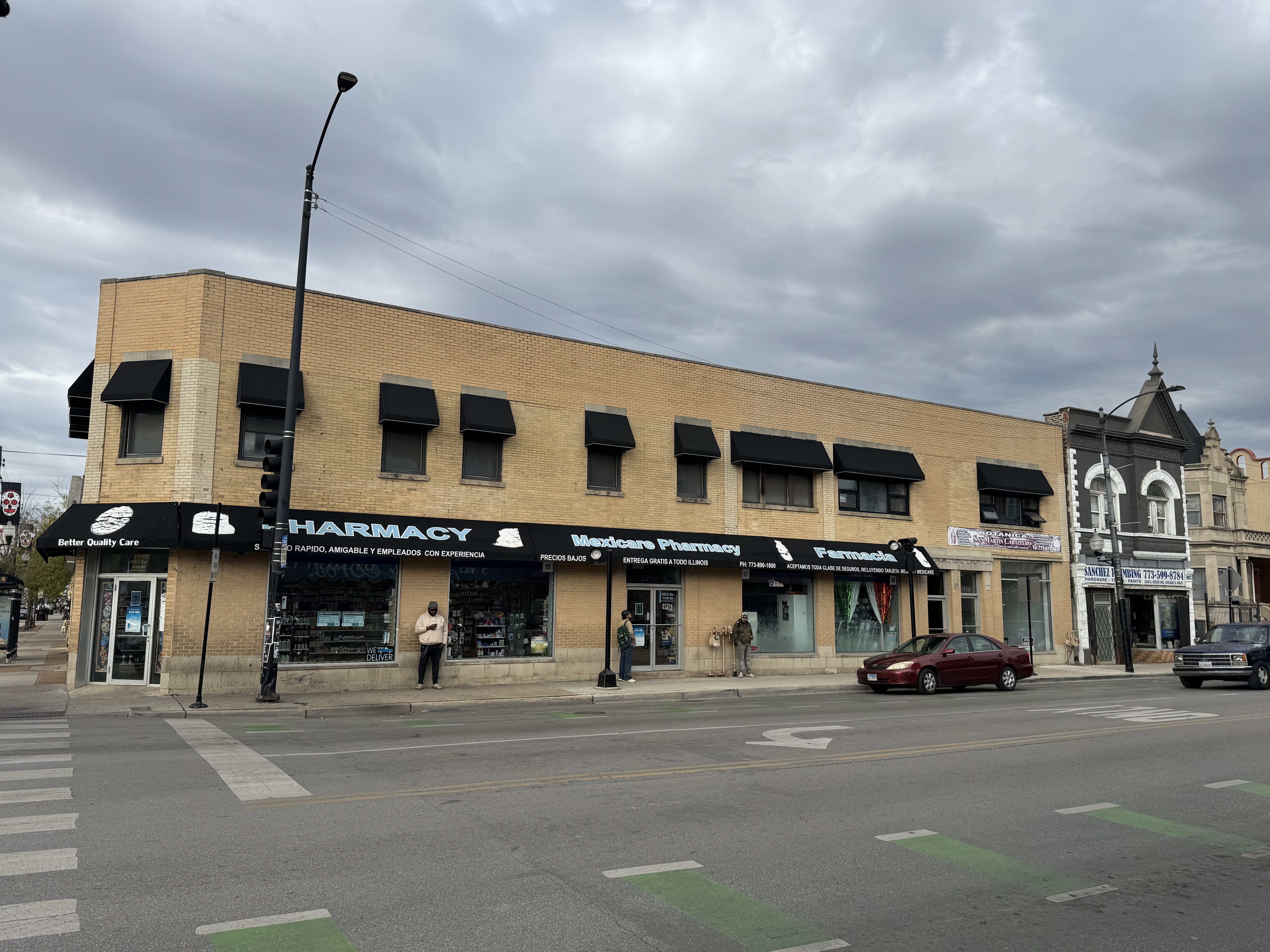 3200-3210 West 26th Street Chicago, IL 60623 - Photo 1 of 3 a city street lined with buildings and cars