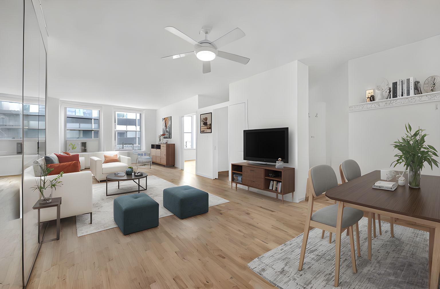 a living room with furniture wooden floor and a flat screen tv