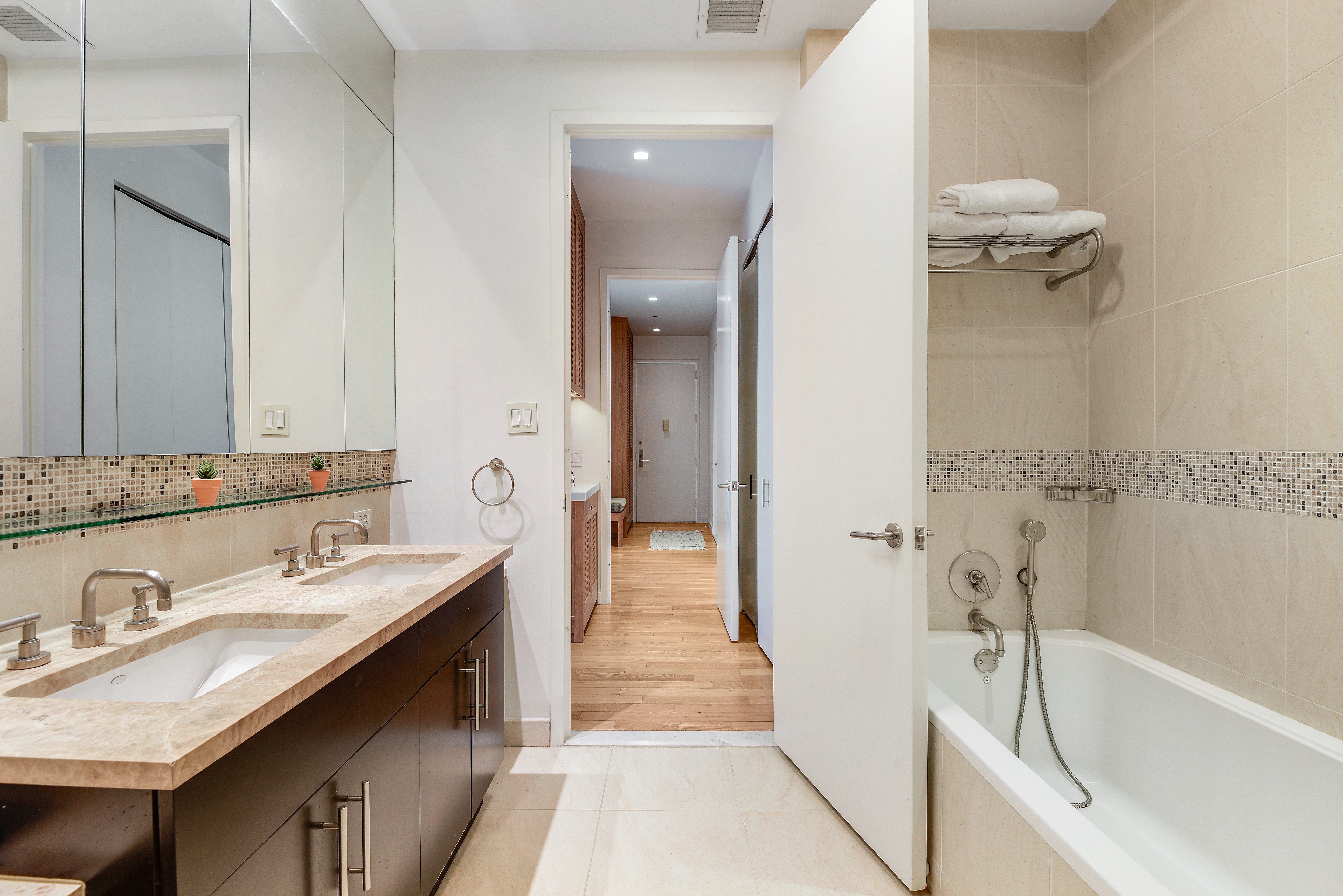 325 5th Avenue, Unit 16C Manhattan, NY 10016 - Photo 9 of 25 a bathroom with a granite countertop sink a toilet and bathtub