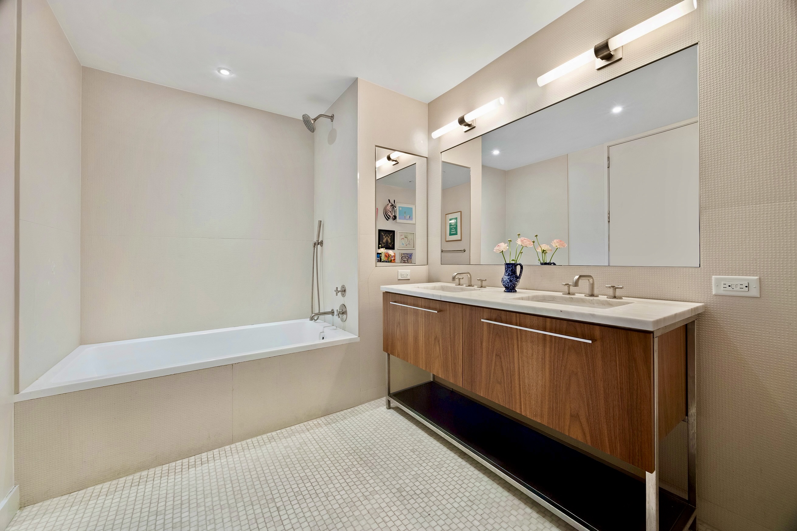 90 Furman Street, Unit N510 Brooklyn, NY 11201 - Photo 21 of 31 a bathroom with a double vanity sink a mirror and a bathtub