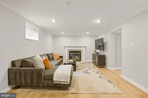 a living room with furniture flat screen tv and a fireplace