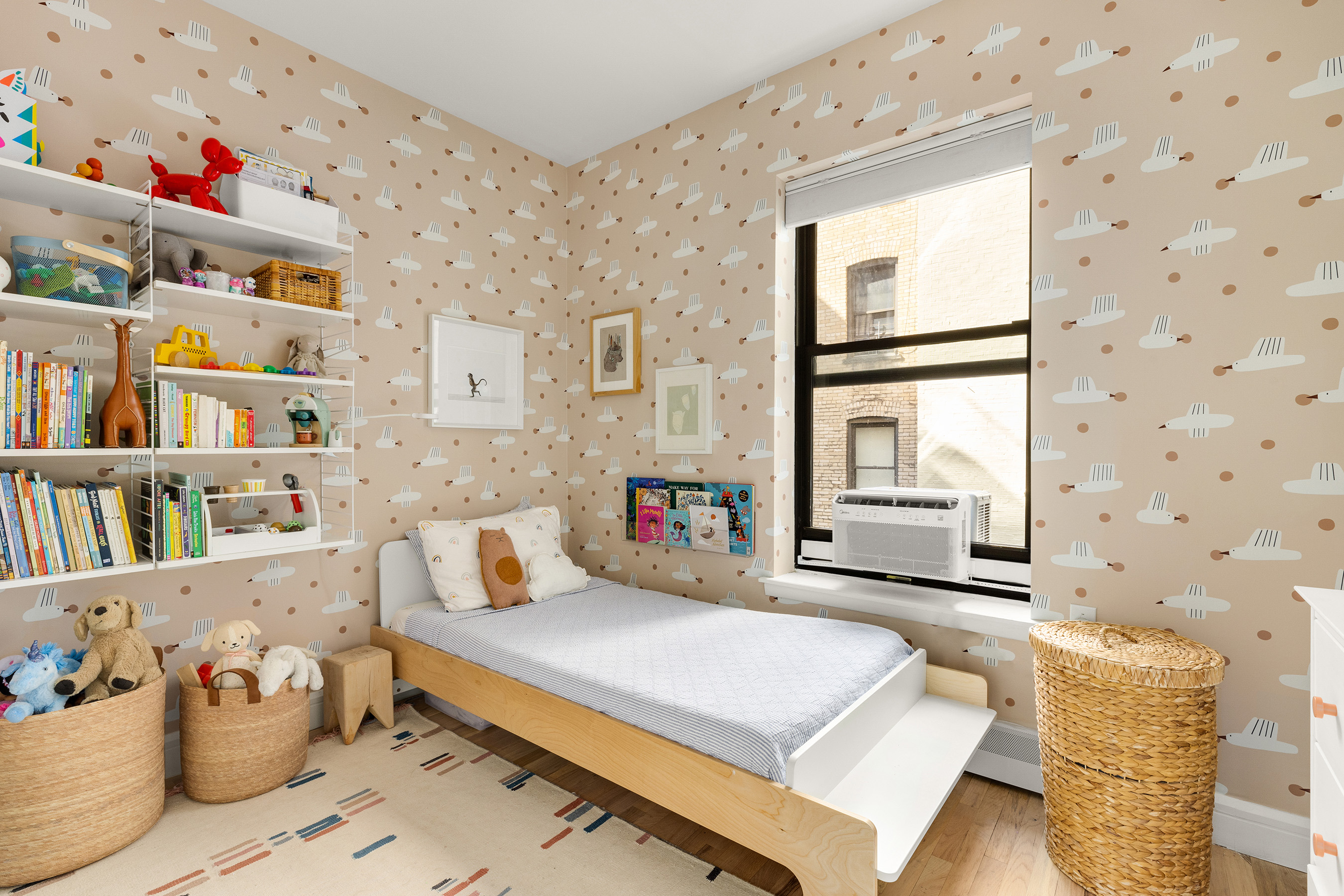 115 Eastern Parkway, Unit 3H Brooklyn, NY 11238 - Photo 6 of 12 a bedroom with furniture and a book shelf