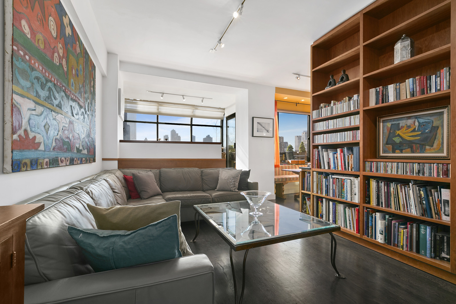 130 West 79th Street, Unit 17A Manhattan, NY 10024 - Photo 3 of 15 a living room with furniture a book shelf and a book shelf