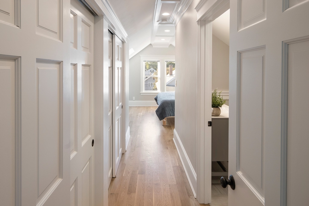 48-50 Amsden Street, Unit 2 Arlington, MA 02474 - Photo 19 of 34 a view of a hallway with wooden floor and staircase