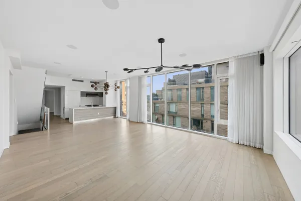 a view of empty room with wooden floor and fireplace