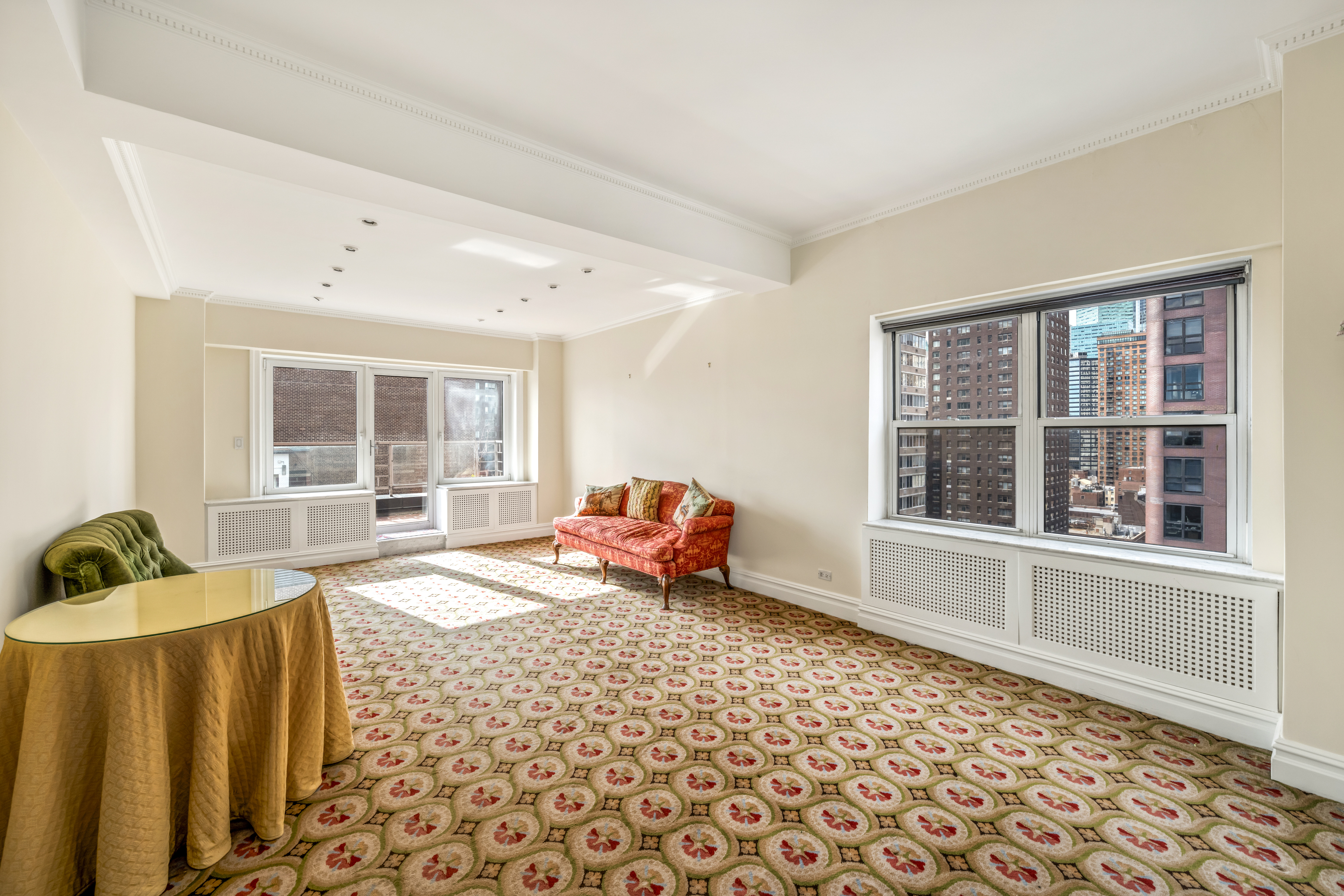 50 Sutton Place South, Unit 21L Manhattan, NY 10022 - Photo 2 of 12 a living room with furniture and a window