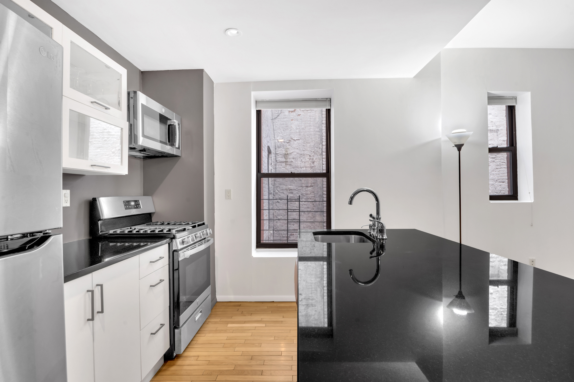 277 Nostrand Avenue, Unit 3A Brooklyn, NY 11216 - Photo 3 of 10 a kitchen with stainless steel appliances granite countertop a stove a sink and a refrigerator