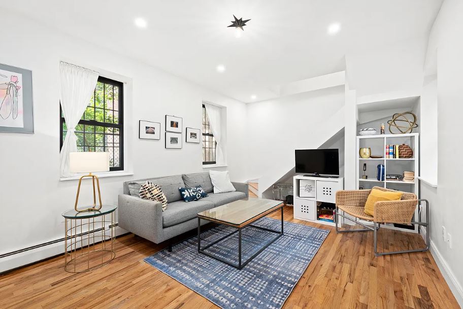 400 West 154th Street, Unit 1 Manhattan, NY 10032 - Photo 4 of 10 a living room with furniture and a flat screen tv