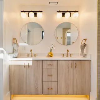 a bathroom with a sink mirror and vanity
