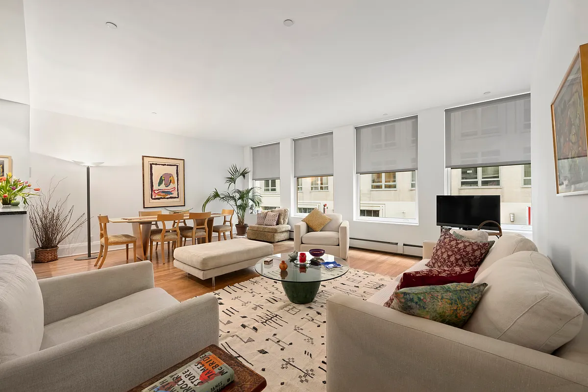 102 Fulton Street, Unit 2E Manhattan, NY 10038 - Photo 1 of 7 a living room with furniture or couch and a wooden floor