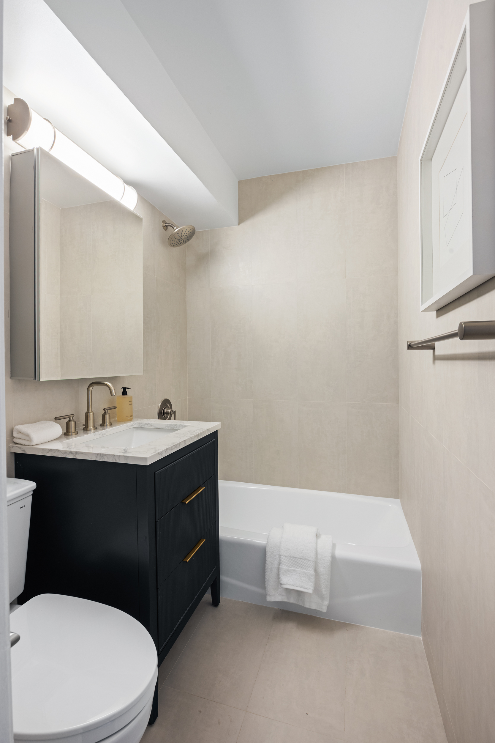 166 East 35th Street, Unit 5F Manhattan, NY 10016 - Photo 8 of 11 a bathroom with a sink a toilet and mirror