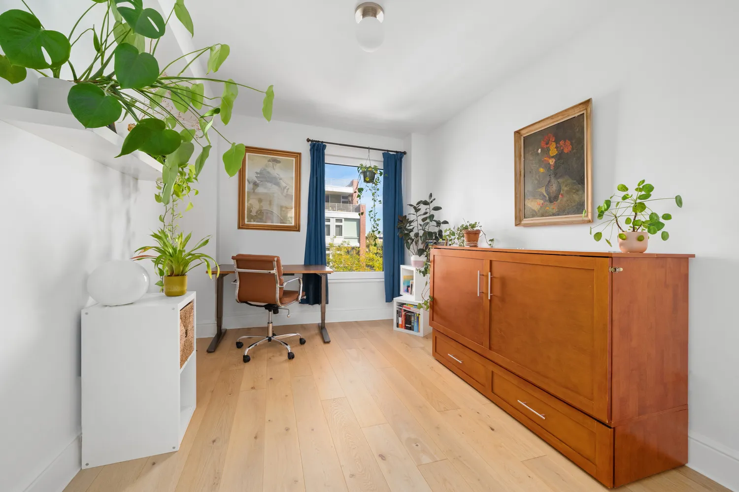 a living room filled with furniture and a potted plant