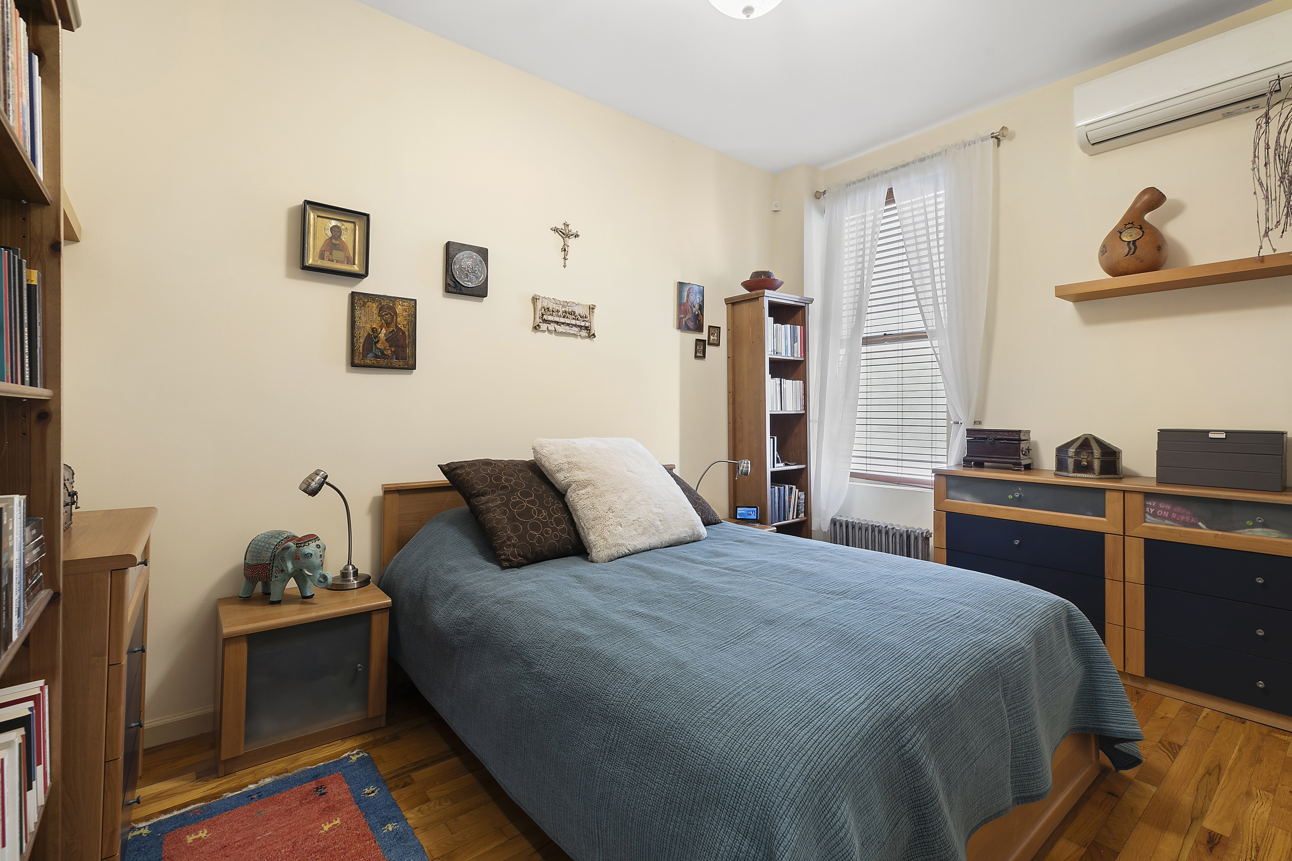 60-38 68th Road Queens, NY 11385 - Photo 7 of 14 a bedroom with a bed and a desk