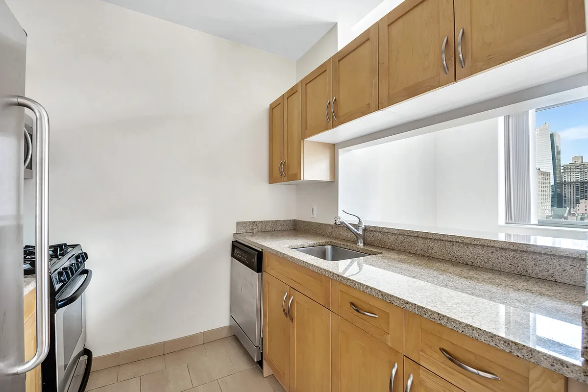 250 East 30th Street, Unit 10H Manhattan, NY 10016 - Photo 4 of 9 a bathroom with a granite countertop sink and a mirror