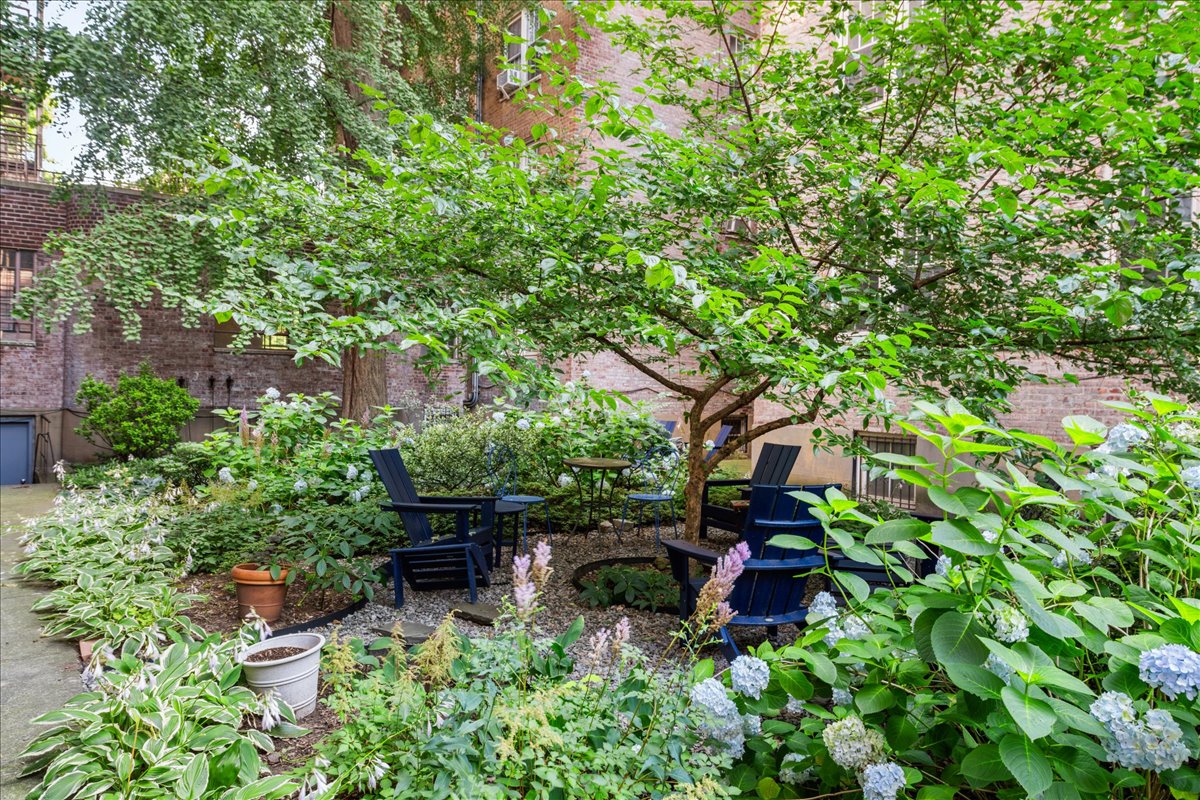 360 Clinton Avenue, Unit 1D Brooklyn, NY 11238 - Photo 14 of 17 a backyard of a house with lots of green space and a fountain