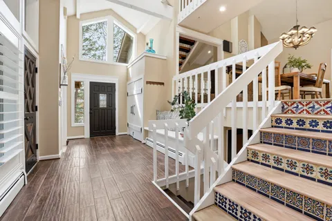 a view of an entryway with wooden floor and front door