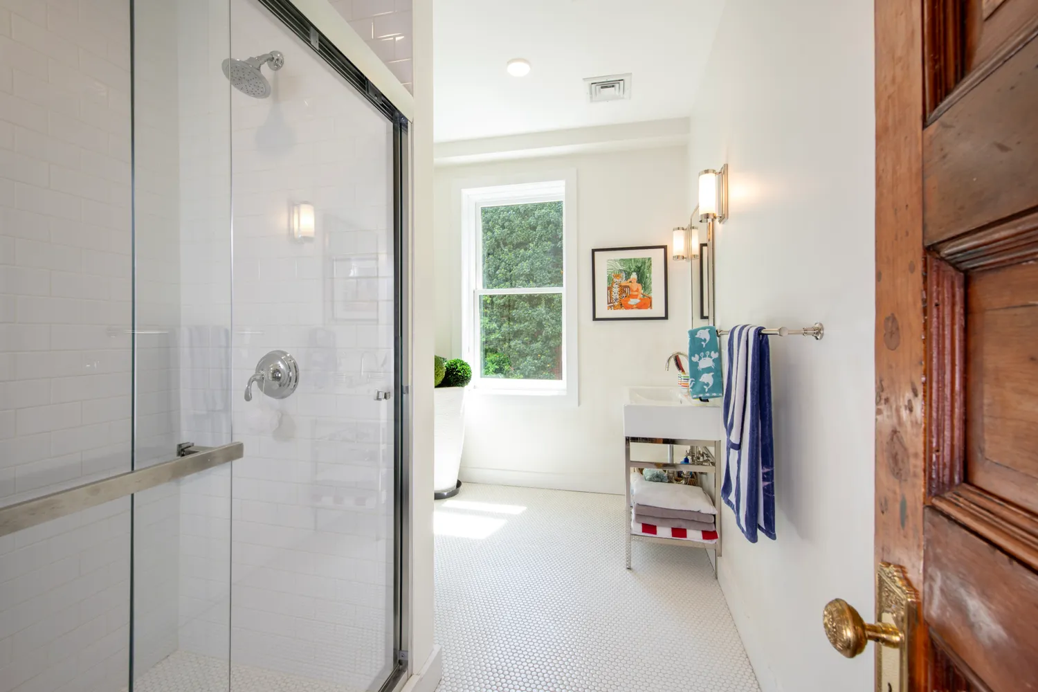 a living room with furniture a fireplace and a chandelier
