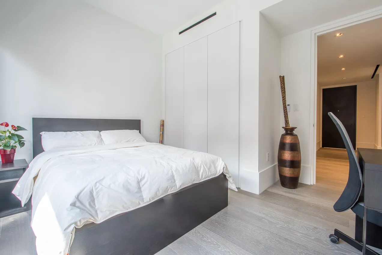 a bedroom with a bed and gym equipment