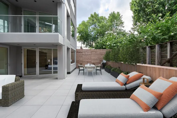 a view of a patio with couches table and chairs and potted plants